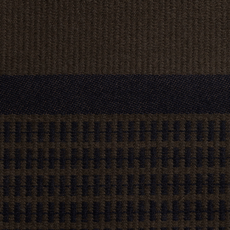 Close-up of the dark brown Danish woven wool fabric from Kjellerup Væveri, featuring a distinctive checkered pattern. The fabric showcases a blend of brown and blue tones, reflecting the exquisite craftsmanship and refined texture characteristic of Kjellerup Væveri's designs, used in the Kelly Rutherford Limited Edition Collection by August Sandgren.